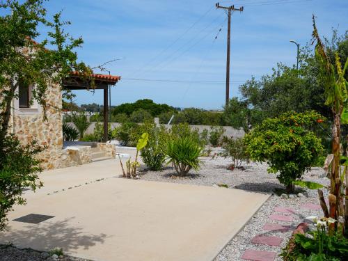 a garden with plants and a walkway at The Garden House in Antimácheia