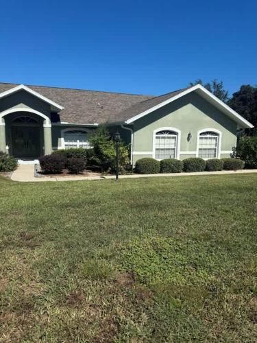 a house with a large lawn in front of it at Golfers Paradise in Hernando
