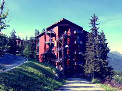 un bâtiment sur une colline à côté d'une route dans l'établissement Duplex mezzanine Les Arcs 1800, à Arc 1800
