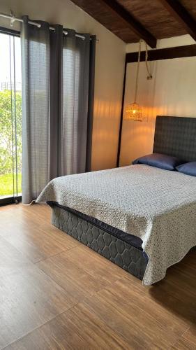 a bedroom with a bed and a large window at Accommodation in Huaral in Huaral