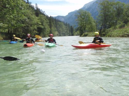 a group of people kayaking on a river at Hotel Bergkristall in Wildalpen