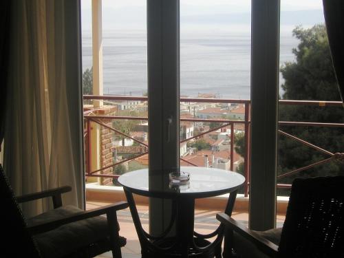 a room with a table and a view of the ocean at Agrabeli Apartments in Limne