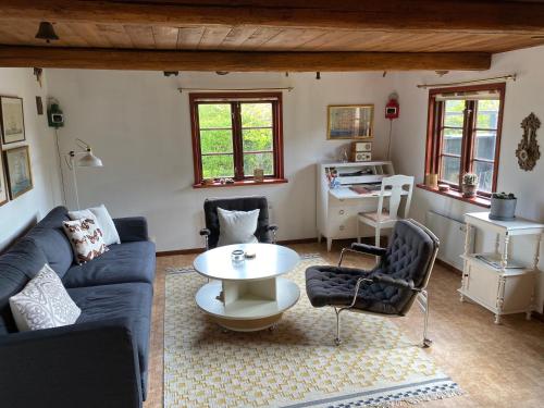 a living room with a blue couch and a table at Charming street house in downtown Kivik, Österlen in Kivik