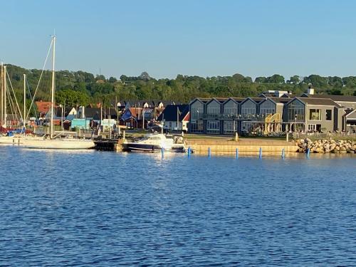 a group of boats docked at a marina with houses at Charming street house in downtown Kivik, Österlen in Kivik