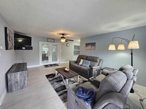 a living room with a couch and a table at Scenic serenity on the water in Inverness