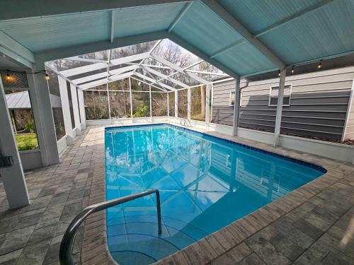 an indoor swimming pool with a glass roof at Scenic serenity on the water in Inverness