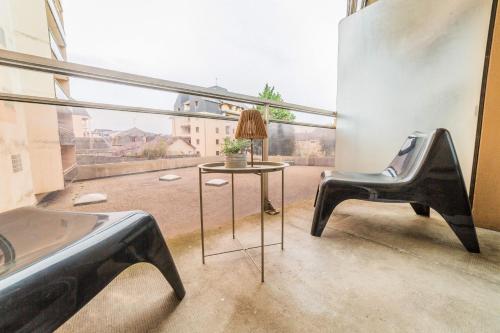 a room with a table and chairs and a large window at L'Icône de la Guierle - 1 Chambre in Brive-la-Gaillarde