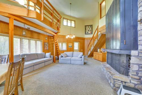 a living room with a couch and a fireplace at Rogers Cabin with Direct Access to Beaver Lake! in Garfield