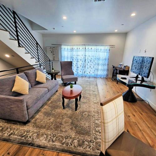 a living room with a couch and a table at Hollywood Homes Free parking close to all things LA in Los Angeles