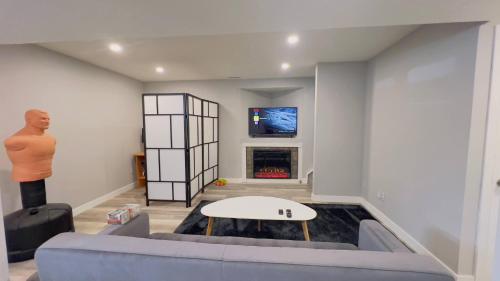 a living room with a couch and a fireplace at Calgary Airport Stay Private Suite 1Bed in Calgary