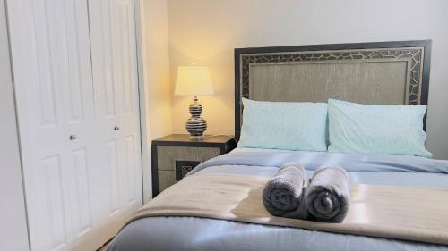 a bedroom with a bed with towels on it at Calgary Airport Stay Private Suite 1Bed in Calgary