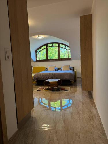 a bedroom with a bed and a large window at Casa Arco in Spišská Nová Ves