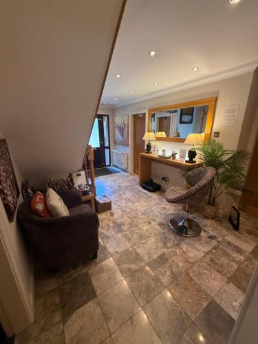 a living room with a couch and a table at Barncroft Luxury Bed & Breakfast in Solihull