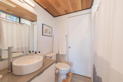 a white bathroom with a sink and a toilet at Stunning Modern Mountain Home for 10 in Truckee New Hot Tub BBQ Close to Slopes Book on Mobile for Promo Price in Truckee