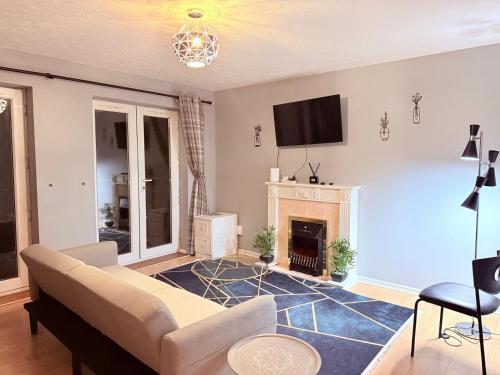 a living room with a couch and a fireplace at Central Comfort Southampton, Free Parking in Southampton
