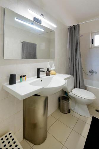 a bathroom with a sink and a toilet at Agali 2 maizonette front of the sea in Akrogiali