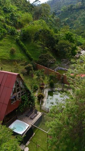 an aerial view of a house with a swimming pool at Hotel Campestre la Playa in Betania