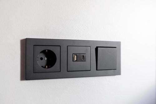 a lightswitch on a wall with a cd on it at Luxury Loft Apartment Akureyri in Akureyri