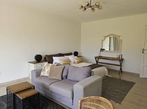 a living room with a couch and a bed at Nkandela Village in Lusaka