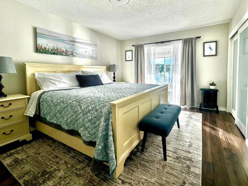 a bedroom with a bed and a blue chair at The Beach House at Deep Bay in Bowser