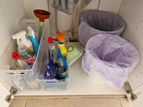 a plastic container with cleaning products and a trash can at Patalavaca beach apartment with stunning ocean view in Patalavaca