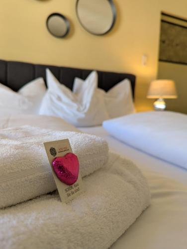 a pile of towels sitting on top of a bed at arte vida boutique guesthouse in Salzburg