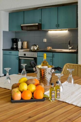 a plate of fruit on a table in a kitchen at Agali 1 Mesonet In Front Of The Sea in Akrogiali