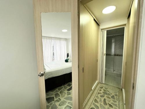 ペレイラにあるExcellent Location Ideal for Large Groupsのベッドと鏡のある小さな部屋