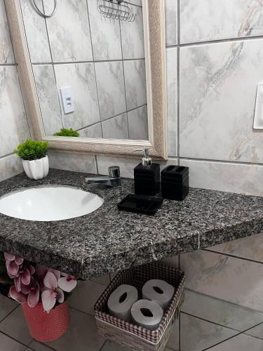 a bathroom counter with a sink and a shower at Marino Beach in Aquiraz