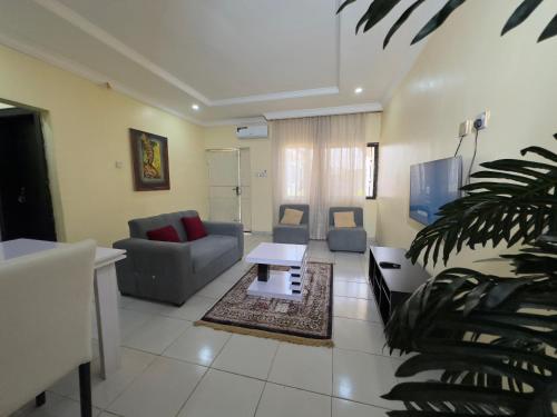 a living room with a couch and a table at 2 Bedroom Service Apartment in Kaduna in Birnawa
