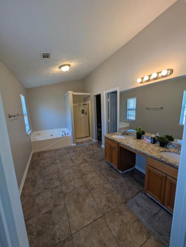 a large bathroom with two sinks and a tub at Charming 3 Bedroom Home in Conley