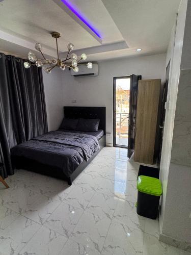 a bedroom with a bed and a chandelier at Serenity Suites in Lagos