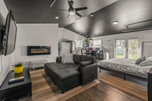a living room with a bed and a couch at Okangan Sunset Bungalow in Vernon