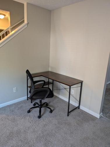 a desk and a chair in a room at Charming 3 Bedroom Home in Conley