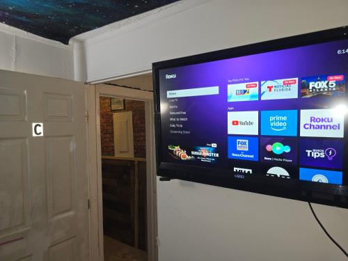 a flat screen tv hanging on a wall at Grateful Hemphill Room C in Atlanta