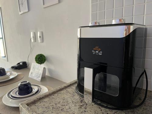 a microwave sitting on top of a kitchen counter at MANAÍRA APART HOTEL in João Pessoa