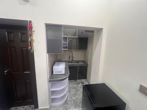 a small kitchen with a sink and a counter at B3 Residence Mirpur - Studio Flat 2 in Rachiāl