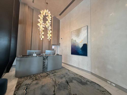 a lobby with a reception desk and a painting on the wall at Star above, Ocean Beyond - Lv 43 Luxury Apartment with Panoramic View on The Star Casino Broadbeach in Gold Coast
