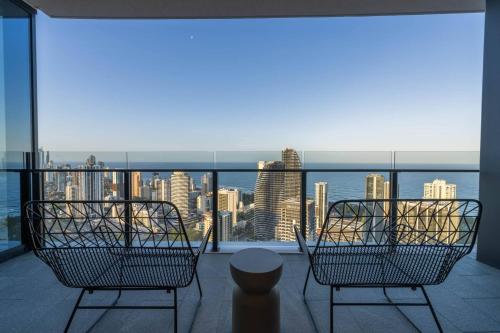 a balcony with two chairs and a view of the city at The Star 2Bedroom Apt - Lv 43 with Panoramic View in Gold Coast