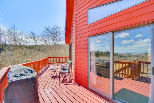 a red deck with two chairs and a table on it at Fairplay Cabin with Mtn View about 4 Mi to Platte River! in Fairplay