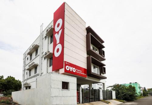 a building with a sign on the side of it at Hotel O Black Pearl Residency in Pīlamedu
