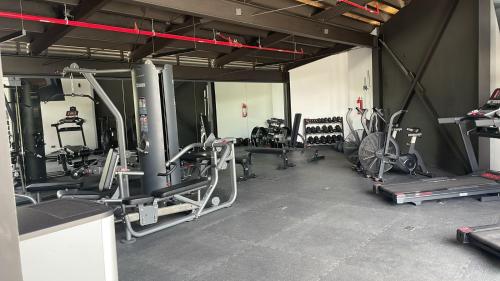 a gym with several tread machines and bikes in it at Club Heasa - Men Only in La Garita