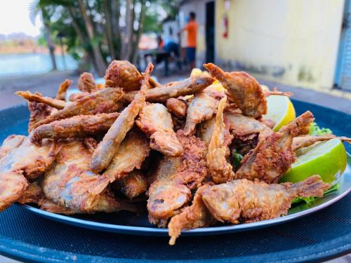 a plate of food withopus and a lime at Pousada Pesque Pague Jango in Cuiabá