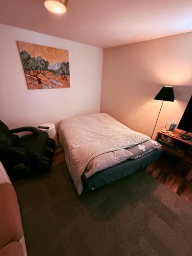 a small bedroom with a bed and a desk at Southeast Portland Parkside Gem on Mount Tabor in Portland