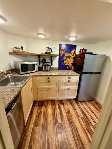 a kitchen with a refrigerator and a sink at Southeast Portland Parkside Gem on Mount Tabor in Portland