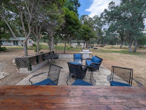 a patio with a table and chairs and trees at Squaw Valley Motel Room 2 in Squaw Valley