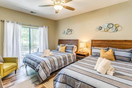 a bedroom with two beds and a ceiling fan at Golf Villa Near Sunset Beach and Intracoastal! in Sunset Beach