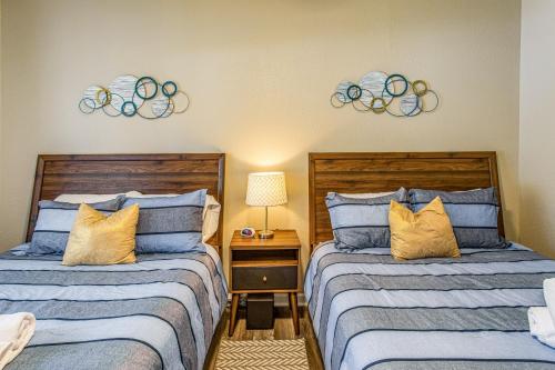 two beds sitting next to each other in a bedroom at Golf Villa Near Sunset Beach and Intracoastal! in Sunset Beach