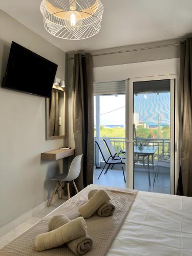 a bedroom with a bed with two towels on it at Marias Apartments in Sarti