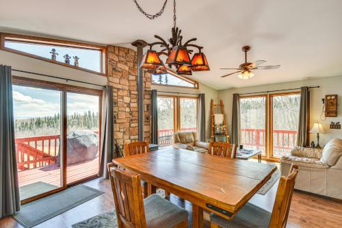 a dining room with a wooden table and a balcony at Fairplay Cabin with Mtn View about 4 Mi to Platte River! in Fairplay